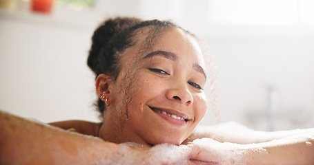 Image showing Happy, peace and face of a woman in a bath at her home for calm, relaxing and self care routine. Smile, headshot and portrait of young female person from Mexico with mindfulness in a tub in bathroom.