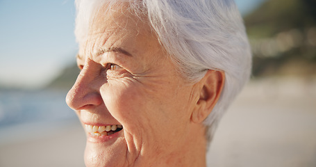 Image showing Senior woman, smile and sunset at a beach with peace outdoor in nature, sea and elderly female person with mindfulness. Relax, happy and calm old lady thinking by the ocean on holiday in retirement