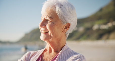 Image showing Senior woman, smile and sunset on beach to relax with peace outdoor in nature, sea and elderly female person with mindfulness. Happy, face and old lady thinking by a ocean on holiday in retirement
