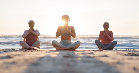 Image showing Beach yoga class, sunset and meditation instructor coaching zen mindset, spiritual chakra healing or breathing exercise. Freedom, calm and people learning pilates, training and coach teaching group