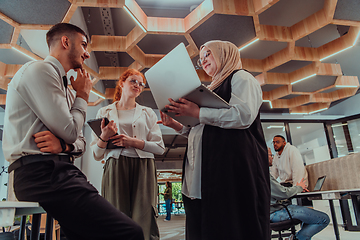 Image showing Young group of business people brainstorming together in a startup space, discussing business projects, investments, and solving challenges.