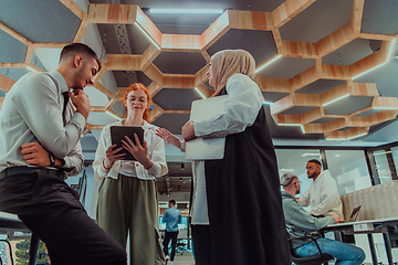 Image showing Young group of business people brainstorming together in a startup space, discussing business projects, investments, and solving challenges.