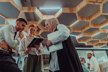 Image showing Young group of business people brainstorming together in a startup space, discussing business projects, investments, and solving challenges.