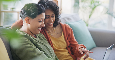 Image showing LGBT, laptop and talking lesbian couple, gay women or queer partner discussion on online shopping choice. Lounge sofa, communication and home conversation of homosexual people chat about omnichannel