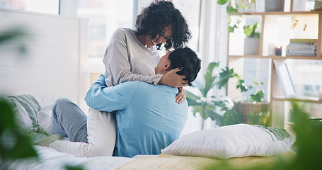 Image showing Hug, home bed and couple kiss with love, care and support in a bedroom with relax and bonding. Embrace, happy young people and smile in a house with a woman and man together with romance in morning