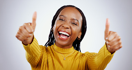 Image showing Thumbs up, excited black woman and portrait in studio for success, winning deal and achievement on white background. Happy model, emoji and celebrate feedback, voting yes and thank you for excellence