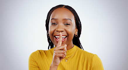 Image showing Secret, portrait and black woman with finger on lips in studio for privacy, news or announcement on grey background. Gossip, whisper and face of happy female model with confidential, hand or emoji