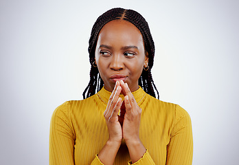 Image showing Thinking, black woman and scheme hands in studio for evil, planning or revenge on grey background. Plotting, villain and African female model with steeple emoji for brainstorming, spy or mischief