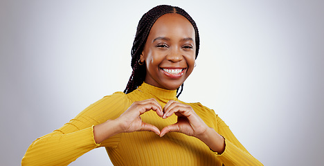 Image showing Heart, hands and portrait of woman in studio for kindness, icon and charity donation on white background. Happy african model show sign of love, emoji and thank you for hope, support or care of peace