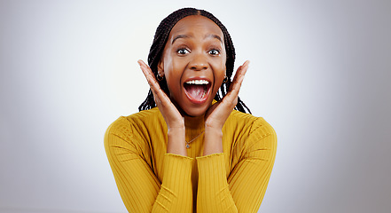 Image showing Wow, news and hands on face of black woman in studio happy with competition, prize or bonus on grey background. Surprise, omg or portrait of African lady winner with mind blown emoji or lotto results