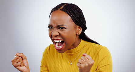 Image showing Angry, black woman and frustrated face with scream, shout and yelling in studio white background. Crisis, stress and person voice anger, rage or crazy emoji with problem, mistake or annoyed with fail