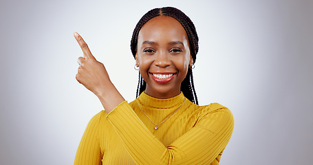 Image showing Black woman, portrait and pointing in studio for advertising information, deal or choice on white background. Happy model, presentation or mockup space for feedback, promotion or announcement of news