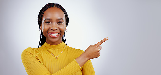 Image showing Portrait, smile and black woman with hand pointing in studio for presentation, checklist or promo on grey background. Timeline, schedule and face of female model show faq, menu or step, guide or info
