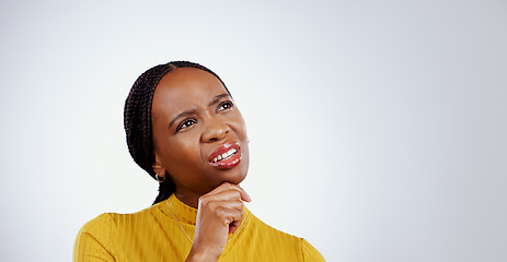 Image showing Thinking, confused and black woman in a studio with memory, brainstorming and planning facial expression. Guess, question and young African female model with solution face isolated by gray background