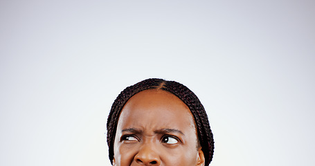 Image showing Confused, face and eyes of black woman thinking with doubt, questions or remember idea in white background. Mockup, space and person frustrated with a memory, choice or planning a decision in studio