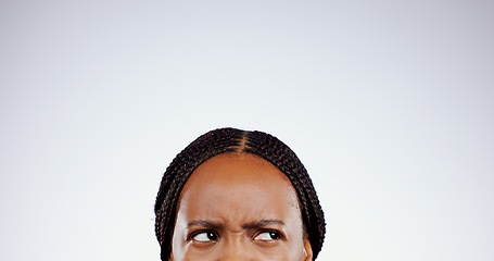 Image showing Thinking, face and eyes of confused black woman with doubt, questions or remember idea in white background. Mockup, space and person frustrated with a memory, choice or planning a decision in studio