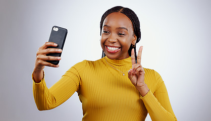 Image showing Studio, peace sign or black woman taking selfie on social media with confidence, post or smile. African lady, memory or happy influencer taking a photograph, vlog or picture online on grey background