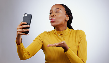 Image showing Studio, kiss or black woman taking selfie on social media with confidence, post or smile online. African lady, memory or beauty influencer taking a photograph, vlog or picture on grey background