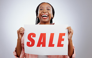 Image showing Portrait, sale sign or black woman by discount deal, offer or launch for poster or business advertising. Happy, studio or person with board for message, marketing or promotion card on grey background