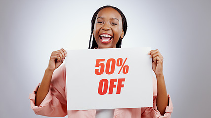 Image showing Portrait, sale sign or happy black woman by discount deal, 50 percent off offer or launch ad. Excited, smile or person with board for message, marketing or promotion card on grey background in studio