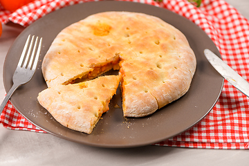 Image showing Pizza calzone on wooden background