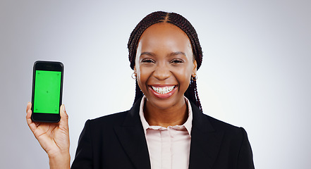Image showing Happy woman, phone and green screen for website design, social media marketing or information in studio. Business portrait of african employee with mobile app and online space on a white background