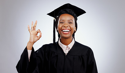 Image showing Graduation, okay hands and woman or student success in education, learning or college achievement in studio. Portrait of happy african graduate with yes or excellence emoji on a white background