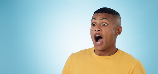 Image showing Wow, surprise and shocked man in studio with news, information or promotion on blue background. Omg, emoji and face of male model with unexpected announcement, gossip or confused by secret giveaway