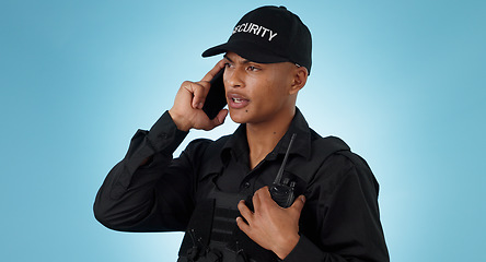 Image showing Security guard, phone call and man with communication in a studio with police and law enforcement. Blue background, surveillance and officer with mobile discussion and talking for safety and danger