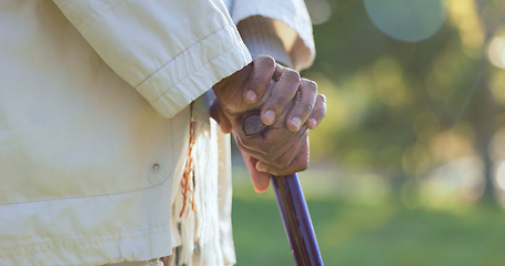 Image showing Hands, walking stick and person with disability outdoor for rehabilitation, support or help in retirement. Closeup, sick senior and cane for balance of parkinson, arthritis and healthcare aid in park