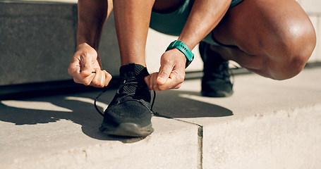 Image showing Hands, tie and footwear with a sports person on steps in the city, getting ready for a running workout. Fitness, exercise and runner or athlete feet training closeup in urban town to improve health