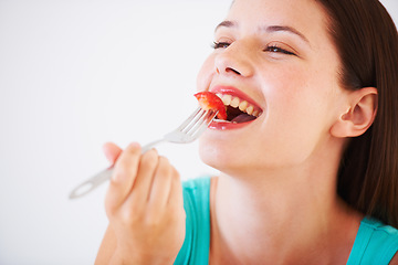 Image showing Health, strawberry and woman with fruit in studio eating for nutrition, wellness and snack. Food, happy and face of person with berries for balance diet, detox and lose weight on white background