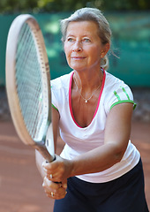 Image showing Woman, tennis racket and ready serve on court for outdoor sport, competition or game match. Senior, female person and ball practice as retirement hobby or mobility training, exercise or summer fun