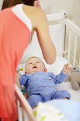 Image showing Mother, baby and crib in nursery with love, bonding and playing for child development and relationship. Woman, infant or newborn in bedroom of home for bedtime, care and routine with pacifier and toy