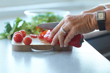 Image showing Hands on chopping board, vegetables and knife on counter in kitchen cooking food. Closeup of cutting plants on table, preparation and tomato, pepper and nutrition for healthy lettuce salad in home