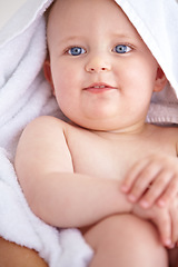 Image showing Baby, face and towel wrap for bath clean for hygiene or childhood development, wash or fresh. Child, kid and cloth for dry skin body for wellness or warm for safety or infant care, shower or love