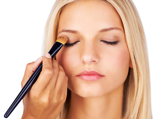 Image showing Eyeshadow, makeup brush and woman in studio with hands for beauty, wellness or glamour makeover on white background. Powder, cosmetics lady model face with beautician for professional eye application