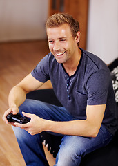 Image showing Man, video game and home on sofa, controller or smile for online competition, relax or press in lounge. Gamer person, playing and idea with click for strategy, streaming or digital challenge on couch