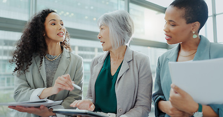 Image showing Business woman, meeting and documents in team discussion, brainstorming or collaboration at office. Female person or group of employees with paperwork in financial planning or strategy at workplace