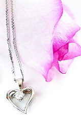 Image showing Diamond necklace on rose