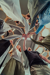 Image showing A group of young businessmen offer their hands together, symbolizing togetherness in the business world