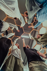 Image showing A group of young businessmen offer their hands together, symbolizing togetherness in the business world