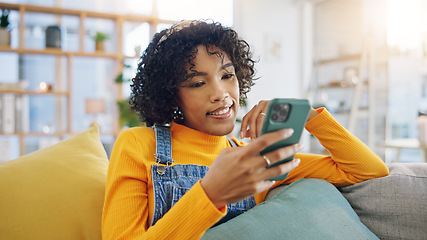 Image showing Phone, social media and relax with a woman on a sofa in the living room of her apartment for communication. Mobile, contact and app with a young person typing or reading a text message in her home