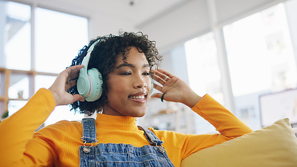 Image showing Music, happy and dance with woman on sofa for streaming, relax and energy. Freedom, media and online radio with person listening to headphones in living room at home for technology, sound and audio