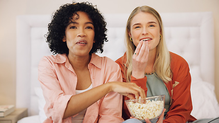 Image showing Television, happy and women friends on a bed with popcorn for movie, comedy or standup show at home. Comic, snack and ladies watching tv in a bedroom laugh, bond and relax with streaming subscription