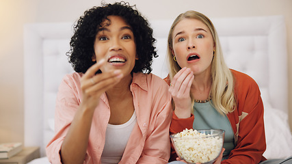 Image showing Horror, television and women friends with popcorn on bed for scary, movie or serial killer documentary at home. Watching tv, face and ladies in bedroom with terror, film or video, snack and streaming