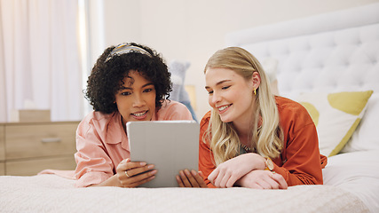 Image showing Couple of friends, tablet and bedroom for social media, movie streaming service and film choice. Young women relax on bed and scroll on digital technology for video, internet and website at home