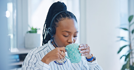 Image showing Happy black woman, call center and drinking coffee in customer service, support or telemarketing at office. African female person, consultant or agent enjoying hot beverage in contact us at workplace