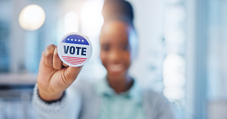 Image showing Hand, vote and badge with a black woman in government for support or motivation of a political campaign. Portrait, smile and democracy with a happy voter holding her pin of choice in a party election