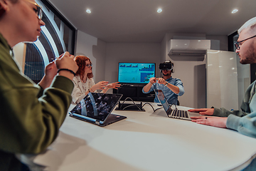 Image showing A diverse group of businessmen collaborates and tests a new virtual reality technology, wearing virtual glasses, showcasing innovation and creativity in their futuristic workspace